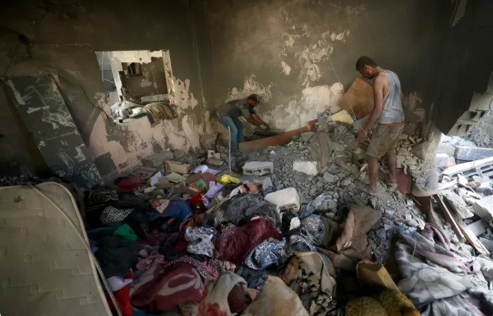 Des Palestiniens recherchent leurs effets personnels après une frappe israélienne dans le camp de réfugiés de Bureij, dans le centre de la bande de Gaza, le 16 juillet 2026. [AFP]