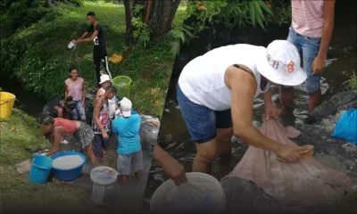 Face aux coupures d'eau à Résidence Atlee, des habitants font leur lessive à la rivière