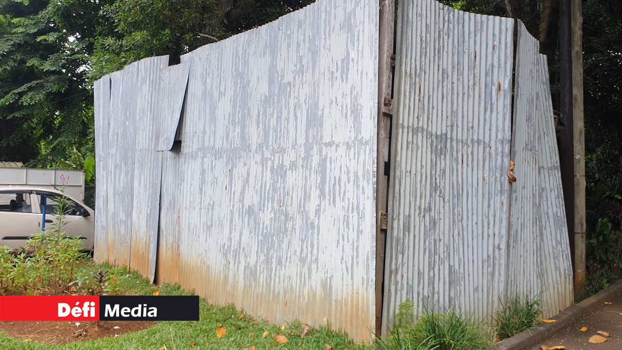 Dans la cour du musée de Mahébourg se trouve une structure en tôle cannelé, derrière laquelle se cache un ancien wagon de passagers tombant en décrépitude.