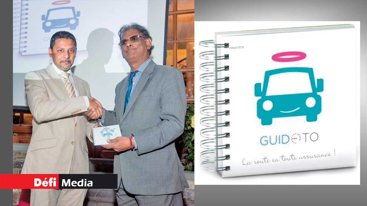 Managing Director of GFA Insurance,  Abdel Ruhomutally offering a copy of the booklet to the Vice President of the Republic  Paramasivum Pillay Vyapoory.